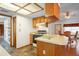 Bright kitchen with wood cabinets, tiled floors, and access to the dining area at 13345 Convent Garden Rd, Brooksville, FL 34613