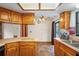 Functional kitchen with wood cabinets and a pass-through to the dining area at 13345 Convent Garden Rd, Brooksville, FL 34613