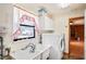 Functional laundry room featuring a utility sink, washer, dryer, and built-in cabinets at 13345 Convent Garden Rd, Brooksville, FL 34613