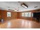 Spacious living room with wood paneling, hardwood floors, and a bay window at 13345 Convent Garden Rd, Brooksville, FL 34613