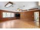 Large living room with wood paneling, hardwood floors, and a bay window at 13345 Convent Garden Rd, Brooksville, FL 34613
