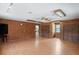 Expansive living room with wood paneling, hardwood floors, and access to laundry room at 13345 Convent Garden Rd, Brooksville, FL 34613