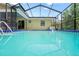 Sparkling screened-in pool reflects the house exterior, providing a relaxing outdoor oasis at 13345 Convent Garden Rd, Brooksville, FL 34613