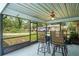 Screened lanai with outdoor dining table and backyard view at 13345 Convent Garden Rd, Brooksville, FL 34613