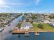 Charming waterfront home with a private dock, boat lift, and lush greenery, offering direct access to the canal at 13836 Darlene Ave, Hudson, FL 34667