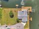 An aerial view shows a backyard, dock, and lift on a canal waterfront at 13836 Darlene Ave, Hudson, FL 34667