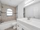 Bright bathroom showcasing a shower-tub combo and a modern vanity at 13836 Darlene Ave, Hudson, FL 34667