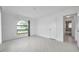 Bright bedroom with arched window, wood-look floors and a view into the en-suite bath at 13836 Darlene Ave, Hudson, FL 34667