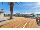 A wide dock overlooking the canal. A large palm tree provides shade at 13836 Darlene Ave, Hudson, FL 34667