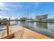 Waterfront home featuring a private boat dock with boat access and beautiful canal views of the boats parked in the back at 13836 Darlene Ave, Hudson, FL 34667
