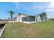 A shot of the exterior of the house facing the backyard and dock on the water at 13836 Darlene Ave, Hudson, FL 34667