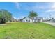 Charming waterfront home features a spacious lawn, mature tree, and a tranquil setting at 13836 Darlene Ave, Hudson, FL 34667