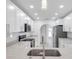 Modern kitchen with white cabinets, stainless appliances, and a stone countertop at 13836 Darlene Ave, Hudson, FL 34667