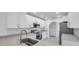 Bright kitchen features stainless appliances, white cabinets, and an undermount sink at 13836 Darlene Ave, Hudson, FL 34667