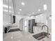 Modern kitchen with stainless steel appliances, stone countertops and bright recessed lighting at 13836 Darlene Ave, Hudson, FL 34667