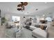 Beautifully staged living room with open-concept design showcasing modern furnishings and seamless flow to the kitchen at 13836 Darlene Ave, Hudson, FL 34667