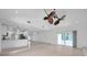 Bright living room featuring tiled floors, recessed lighting, and access to the kitchen at 13836 Darlene Ave, Hudson, FL 34667