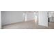 Open-concept living area with tile floors, arched doorways, and seamless flow to kitchen at 13836 Darlene Ave, Hudson, FL 34667