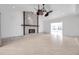 Spacious living room with stone fireplace, open floor plan and tiled floors at 13836 Darlene Ave, Hudson, FL 34667