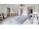 Comfortable main bedroom with a ceiling fan, walk-in closet, dresser, and a sitting area with a cozy chair at 13836 Darlene Ave, Hudson, FL 34667