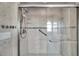 Shower with a glass door and textured tile surround at 13836 Darlene Ave, Hudson, FL 34667