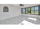 This sunroom features white tile flooring and transom windows at 13836 Darlene Ave, Hudson, FL 34667