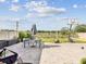 Backyard featuring stone patio, dining set, garden, and basketball hoop, perfect for outdoor enjoyment at 14000 Lugano Ct, Hudson, FL 34669