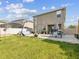 Spacious backyard featuring a stone patio, dining set, above-ground pool, and basketball hoop at 14000 Lugano Ct, Hudson, FL 34669