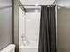 Bathroom featuring tiled walls, shower and tub with a gray shower curtain at 14000 Lugano Ct, Hudson, FL 34669