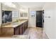 Elegant bathroom with double sinks, granite countertops, and dark wood cabinets, offering a luxurious feel at 14000 Lugano Ct, Hudson, FL 34669