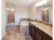 Bright bathroom with a soaking tub, separate shower, and well-lit vanity, offering a spa-like experience at 14000 Lugano Ct, Hudson, FL 34669