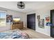 Well-lit bedroom with wood-look floors, a mounted TV, and stylish black closet doors at 14000 Lugano Ct, Hudson, FL 34669