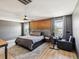 Comfortable bedroom with a queen-size bed, wood accent wall, and large windows providing natural light at 14000 Lugano Ct, Hudson, FL 34669