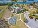 An aerial view of the community center, pool, playground and basketball court near a beautiful lake at 14000 Lugano Ct, Hudson, FL 34669