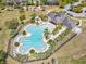 A stunning aerial view highlighting the resort-style pool, clubhouse, and Gathering-friendly playground in a vibrant community at 14000 Lugano Ct, Hudson, FL 34669