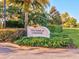 Welcoming entrance sign for The Park at Lakeside, surrounded by lush landscaping and mature trees at 14000 Lugano Ct, Hudson, FL 34669
