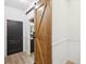 Hallway with barn door leading to bathroom at 14000 Lugano Ct, Hudson, FL 34669