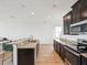Open-concept kitchen boasts granite countertops, stainless appliances, and ample natural light at 14000 Lugano Ct, Hudson, FL 34669