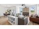 Open concept living area with dining area, lots of natural light, and a modern fireplace at 14000 Lugano Ct, Hudson, FL 34669