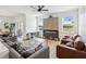 Bright living room featuring fireplace and ample seating at 14000 Lugano Ct, Hudson, FL 34669