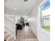 Open-concept living area with wood floors and kitchen, featuring a fireplace and lots of natural light at 14000 Lugano Ct, Hudson, FL 34669