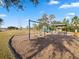 A vibrant community playground offering swings and a covered picnic area near a grassy lawn at 14000 Lugano Ct, Hudson, FL 34669