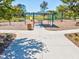 A vibrant community playground featuring swings, climbing structures, and a covered picnic area near a lake at 14000 Lugano Ct, Hudson, FL 34669