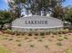 Entrance to the Lakeside community with stone and concrete sign amidst mulch and greenery at 14000 Lugano Ct, Hudson, FL 34669