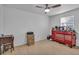 Spacious bedroom with a ceiling fan, large window, and plenty of storage space at 15950 Adobe Dr, Hudson, FL 34667