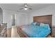 Comfortable bedroom featuring a wood dresser, ceiling fan and a queen-sized bed with stylish bedding at 15950 Adobe Dr, Hudson, FL 34667