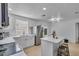 Bright kitchen with stainless steel appliances, white cabinets, quartz countertops, and a breakfast bar at 15950 Adobe Dr, Hudson, FL 34667