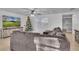 Well lit living room with view of window, fan, and TV at 15950 Adobe Dr, Hudson, FL 34667