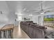 Open-concept living room with a large couch, light wood floors, and a view into the kitchen at 15950 Adobe Dr, Hudson, FL 34667
