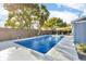 Beautiful in-ground pool with clear blue water, surrounded by lush greenery at 15950 Adobe Dr, Hudson, FL 34667
